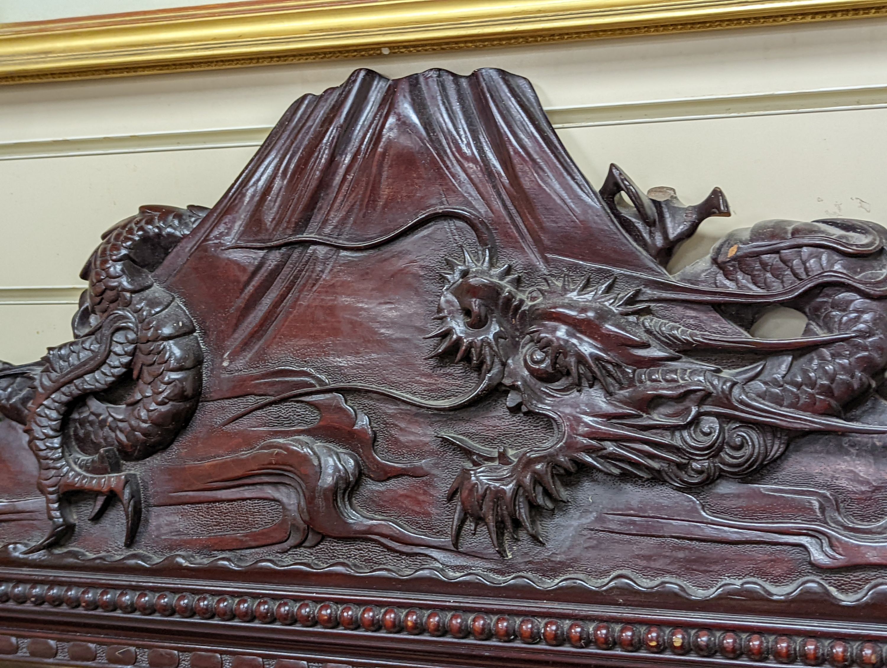 A Japanese carved hardwood dragon overmantel mirror, width 112cm, height 180cm